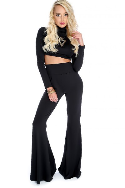 black, long-sleeved, figure-hugging crop top with high-waisted bell-bottoms
