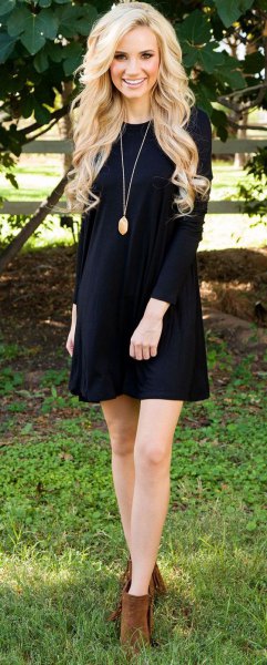 black long-sleeved mini swing dress with camel ankle boots