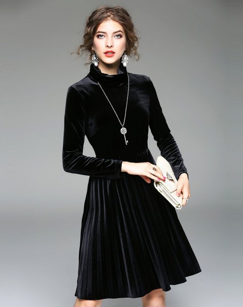 black midi pleated dress made of velvet with long sleeves and mocked neck