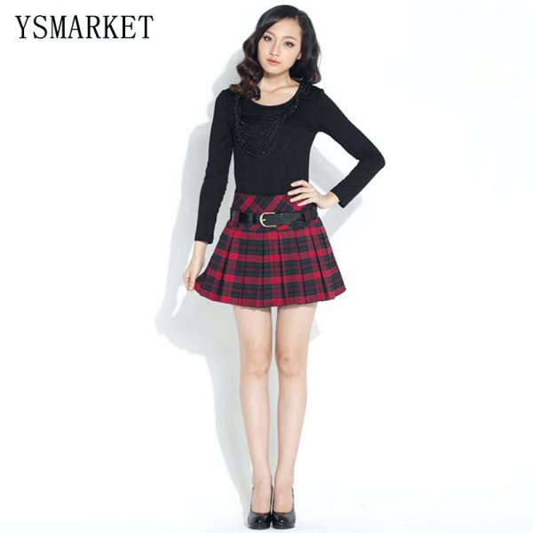 black long-sleeved t-shirt with scoop neckline and red, checked mini strap skirt