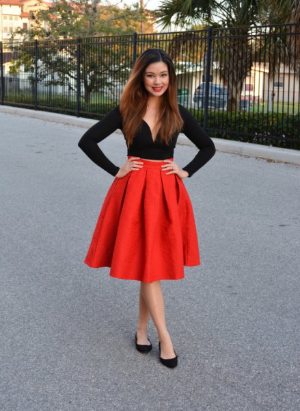 black long-sleeved sweat style top, red flared pleated skirt