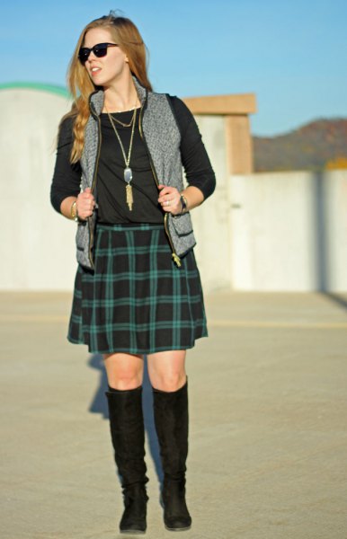 black long-sleeved T-shirt with green checked skirt and gray vest