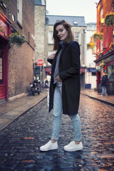 black wool coat with gray turtleneck and white shoes