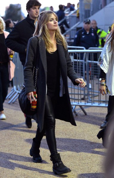black longline wool coat with leather pants and ankle boots