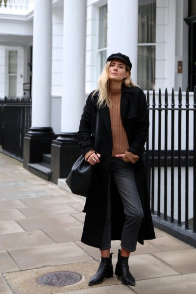 black maxi coat with green ribbed sweater and gray, cropped jeans