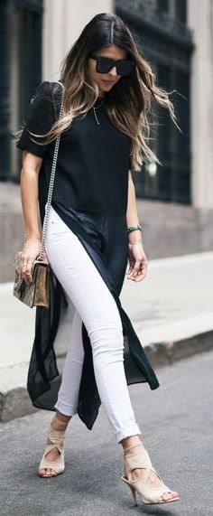 black maxi short-sleeved blouse with high slit and white jeans with cuffs