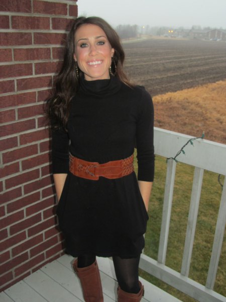 black mini sweater dress with half sleeves and a brown, wide belt