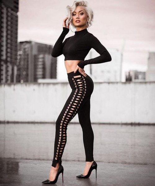 black, short-cut sweater with lacing and narrow pants with lacing
