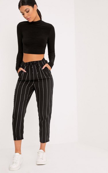black, cropped sweater with stand-up collar and striped, cropped pants with wide legs