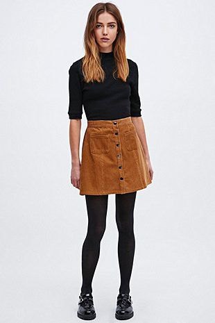 black mock-neck sweater with half sleeves and brown corduroy mini skirt with button placket