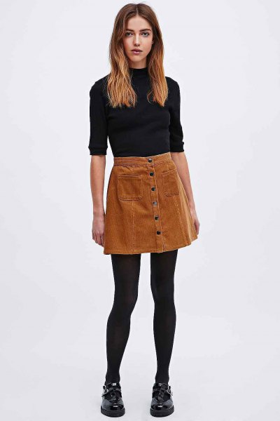black mock-neck sweater with half sleeves and brown corduroy mini skirt
