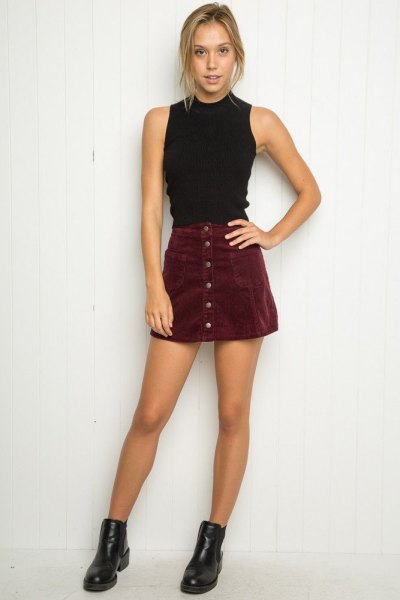 Black halter neck top with a mini skirt made of suede buttons