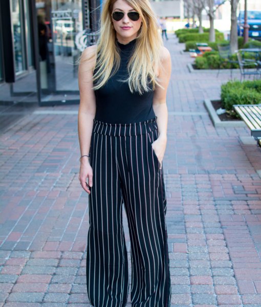 black sleeveless top with stand-up collar and striped pants