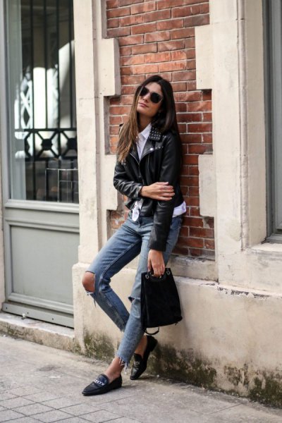 black moto jacket with gray, heavily torn jeans and leather loafers