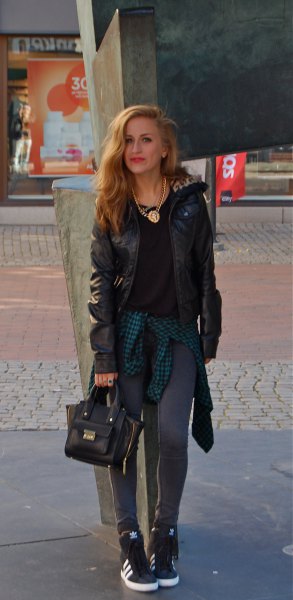black moto jacket with gray leggings and hidden wedge sneakers with high top