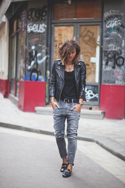 black moto jacket with ripped jeans and leather loafers
