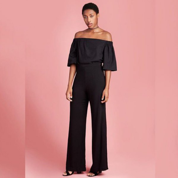 black off-the-shoulder blouse with high pants with wide legs