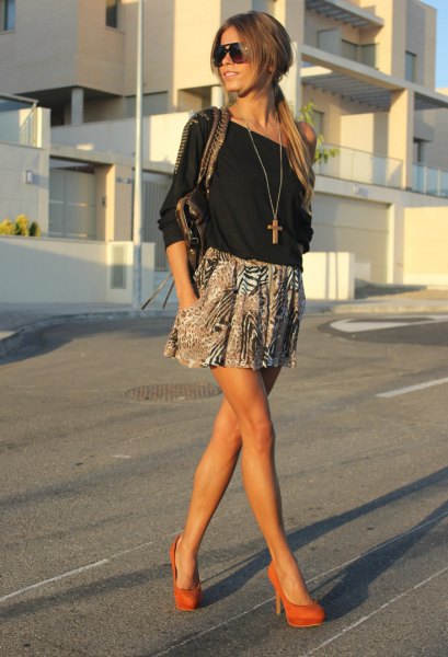 black off-the-shoulder blouse with printed minirater skirt and orange heels