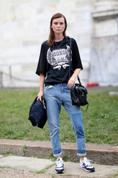 black oversize print t-shirt with relaxed blue jeans with cuffs