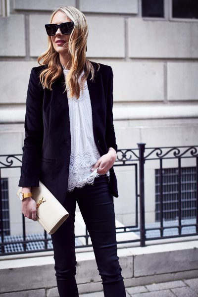black oversized velvet jacket with white tunic top made of lace and slim-fitting jeans