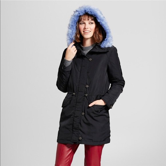 black parka jacket with blue hood and brown leather pants