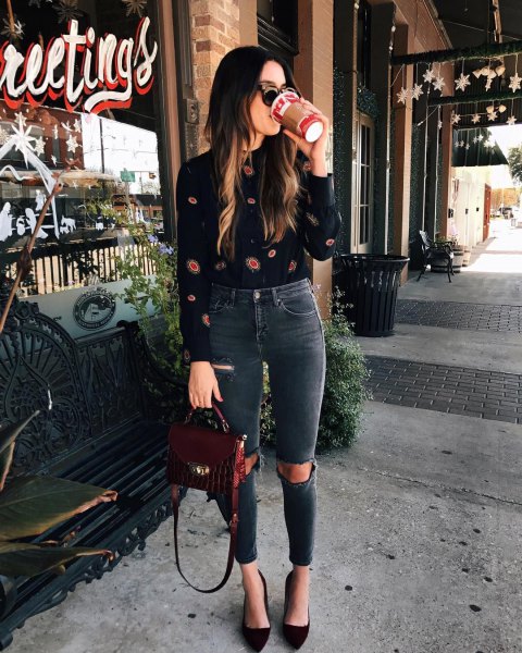 black printed blouse with gray, high-waisted, ripped jeans