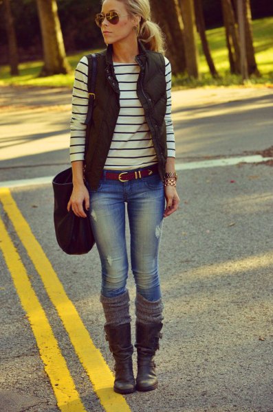 black puffer vest with a striped long-sleeved T-shirt and boots in the middle of the calf