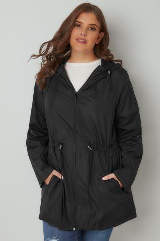 black parka jacket with relaxed fit, sweater with round neck and blue jeans