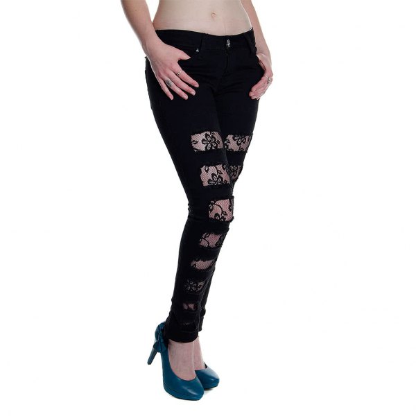 black skinny jeans made of torn lace with dark blue leather heels