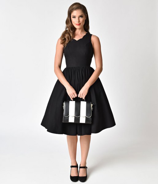 black swing dress with scalloped neckline in the style of the 1950s