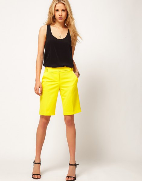 black sleeveless tank top with scoop neckline and yellow shorts