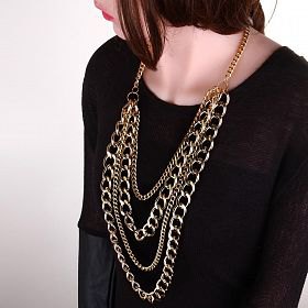 black sweater with scoop neckline and eye-catching gold chain