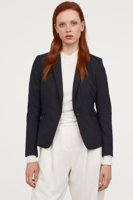 black short and tailored blazer with white high-rise pants with a relaxed fit