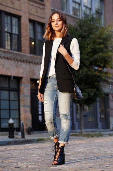 black sleeveless jacket with white long-sleeved T-shirt and boyfriend jeans with cuffs