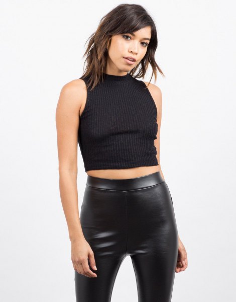 black sleeveless, ribbed, cropped sweater with leather gaiters