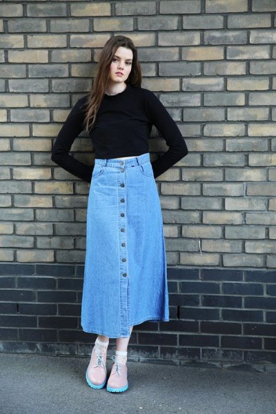black, slightly shortened top with bell sleeves and blue skirt with a long denim button on the front