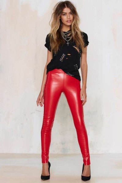 black t-shirt with studded neckline and red, narrow leather pants