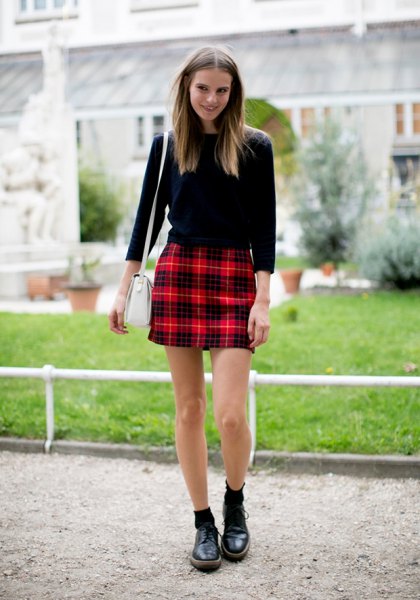 black sweater with red checked high-rise mini skirt
