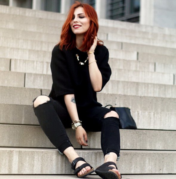 black sweater with knee-torn jeans and slide sandals