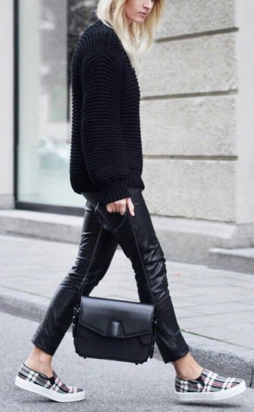 black sweater with leather gaiters and gray checkered shoes