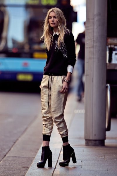 black sweater with white collar shirt and metallic jogger pants