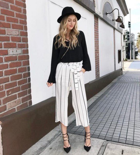 black sweater with white, cropped pants with wide legs