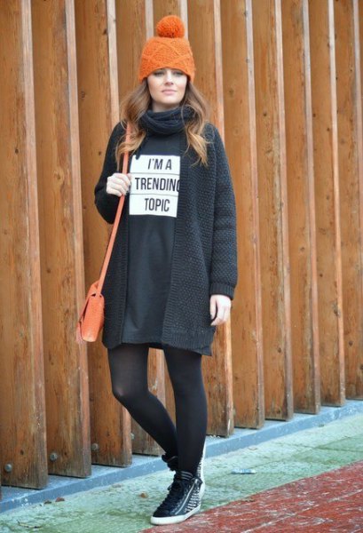 black sweatshirt dress with stockings and hiking boots