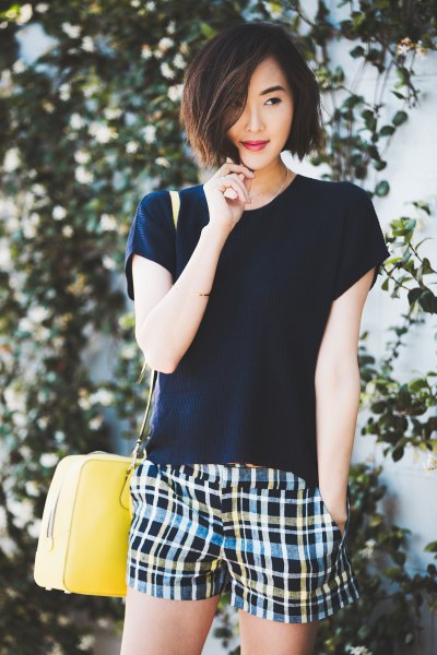 black t-shirt with multicolored checked shorts