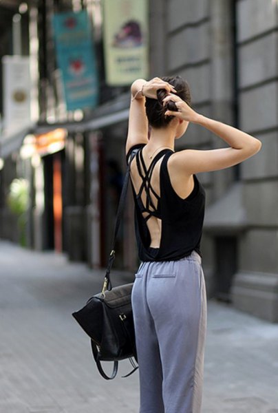 black tank top with gray cotton trousers with a relaxed fit