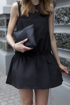 black tank top with minirater skirt and leather handbag