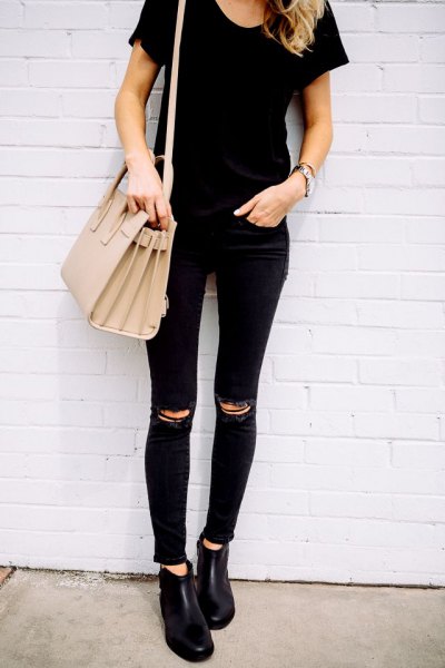 black t-shirt with a torn knee, matches skinny jeans