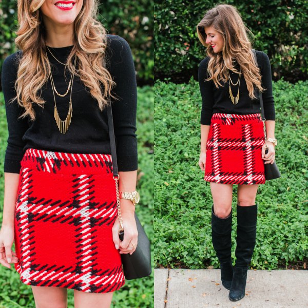 black sweater with three-quarter sleeves and red mini skirt made of checked wool with a high waist