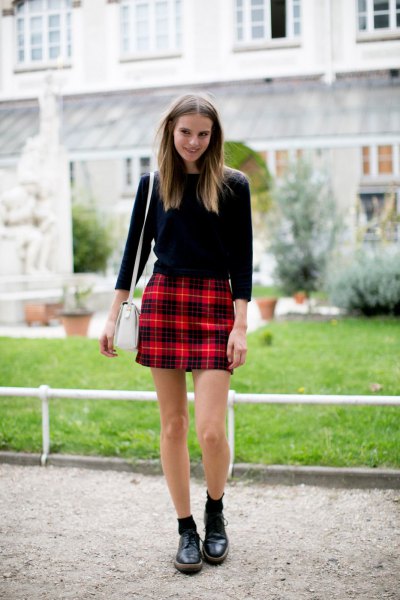 black three-quarter sleeve sweater with red checked mini skirt