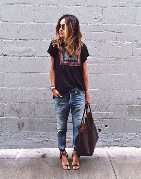 black t-shirt with tribal print with badly torn and washed boyfriend jeans